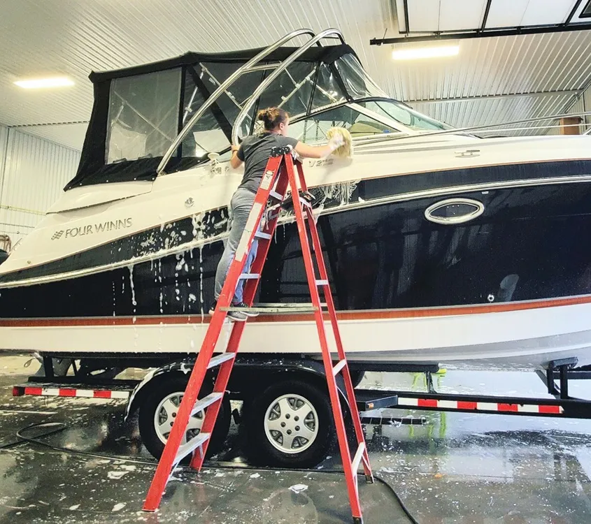 Proglass crew washing a Four Winns cruiser in the shop