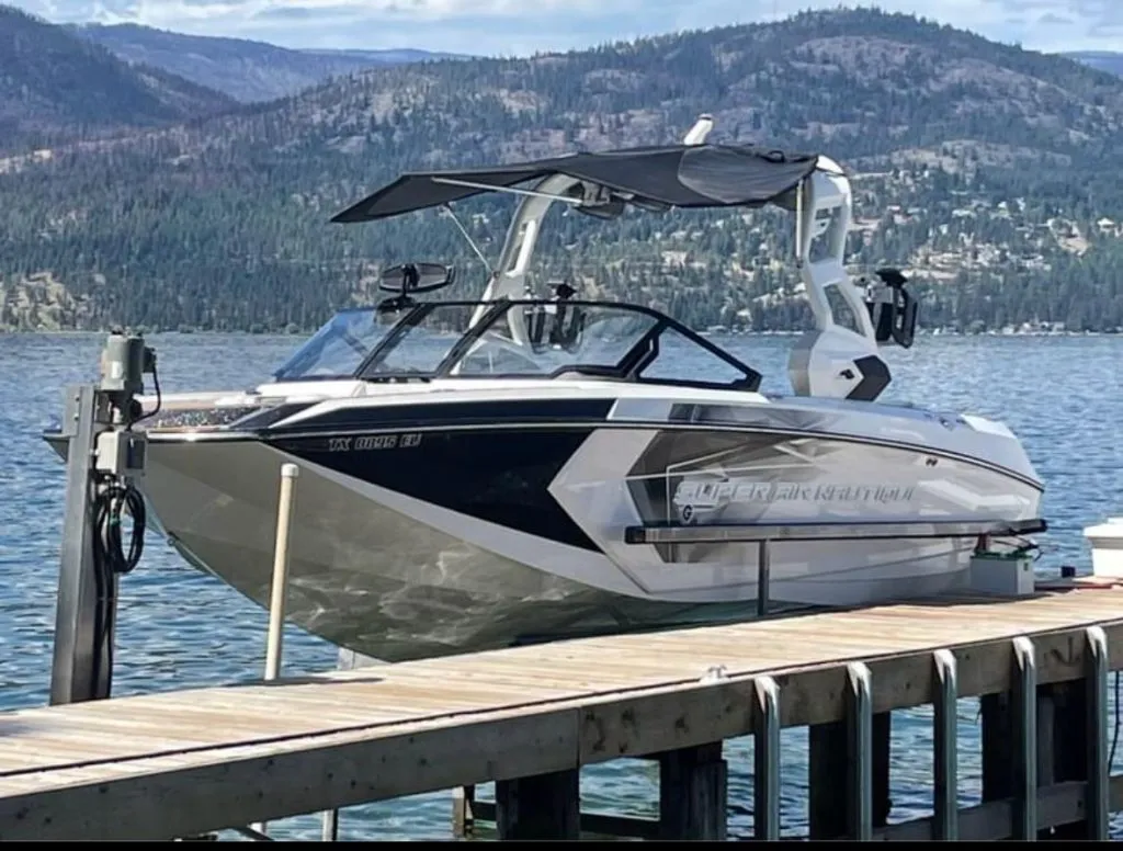 A wake boat on its lift on Okanagan Lake
